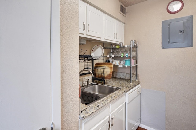 kitchen with dishwasher, sink, white cabinets, electric panel, and light stone countertops