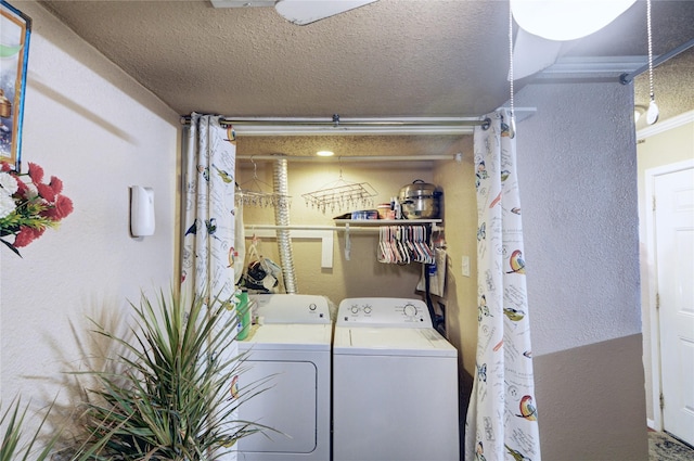 laundry room with independent washer and dryer and a textured ceiling