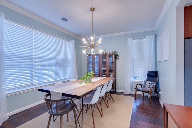 dining room featuring crown molding, dark hardwood / wood-style flooring, and a chandelier