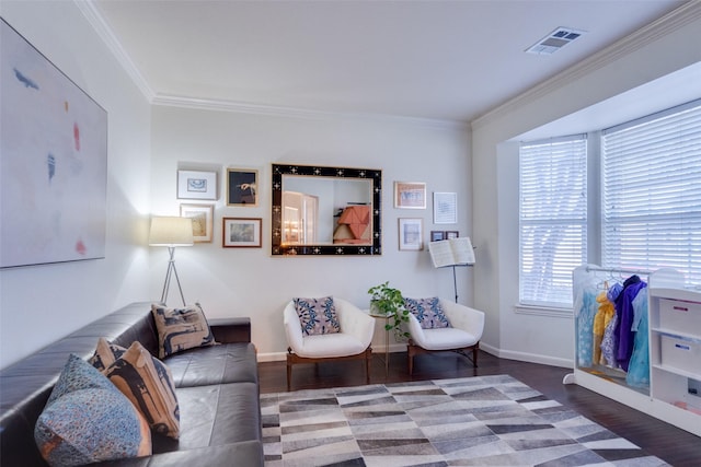 living area featuring hardwood / wood-style flooring and ornamental molding