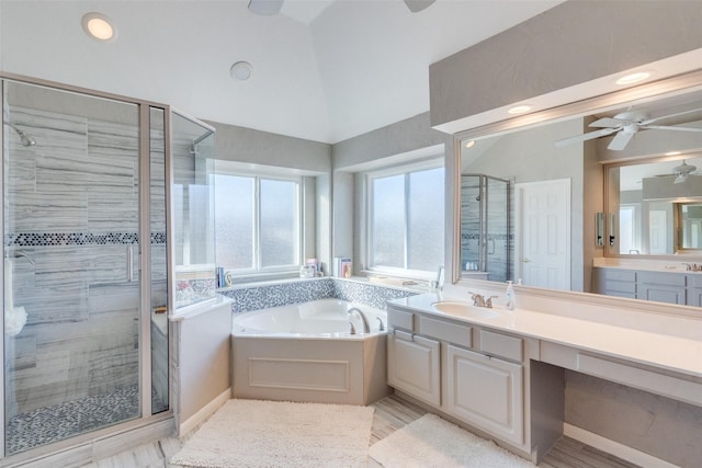 bathroom featuring vanity, lofted ceiling, and plus walk in shower