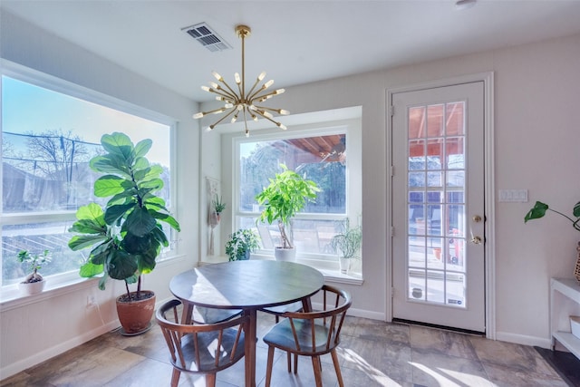 dining space with a healthy amount of sunlight and a chandelier