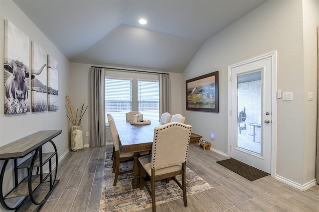 dining space featuring vaulted ceiling