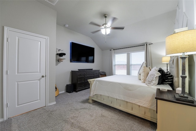 bedroom featuring ceiling fan, vaulted ceiling, and light carpet