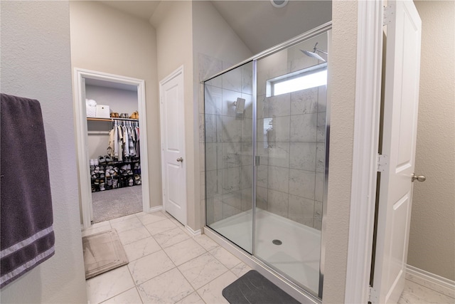 bathroom featuring a shower with shower door