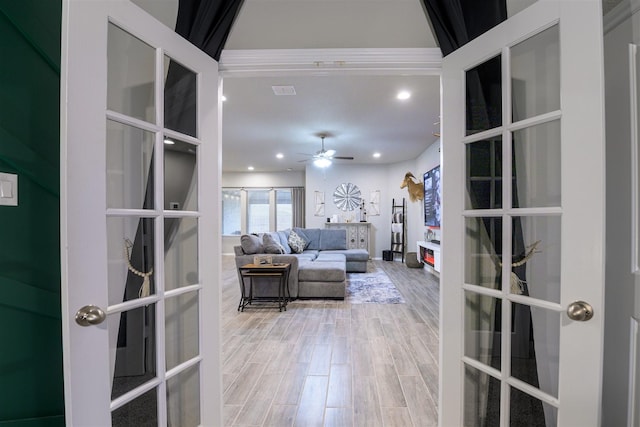 living room featuring hardwood / wood-style flooring, ceiling fan, and french doors