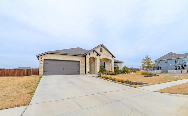 view of front facade featuring a garage and a front lawn