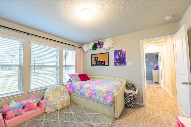 bedroom with carpet floors and a textured ceiling