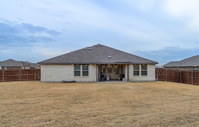 back of property with a patio and a lawn