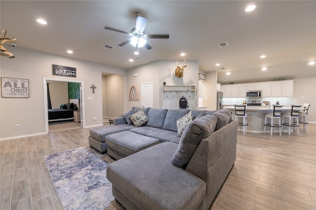 living room featuring ceiling fan and light wood-type flooring