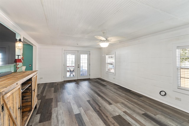 unfurnished living room with dark hardwood / wood-style flooring, french doors, and ceiling fan