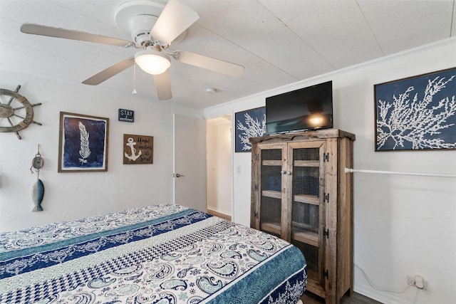 bedroom with ornamental molding and ceiling fan