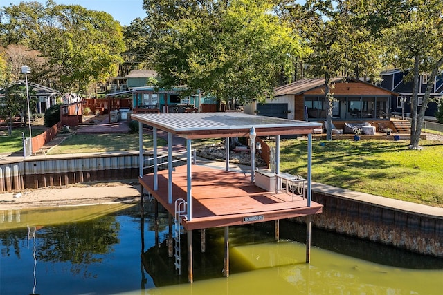 dock area with a water view and a lawn