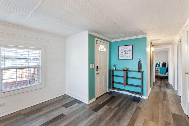 entrance foyer with ornamental molding and hardwood / wood-style floors