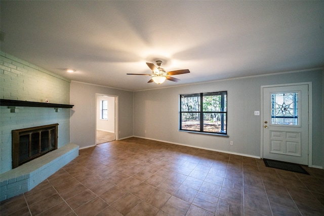 unfurnished living room featuring a fireplace, ornamental molding, and ceiling fan