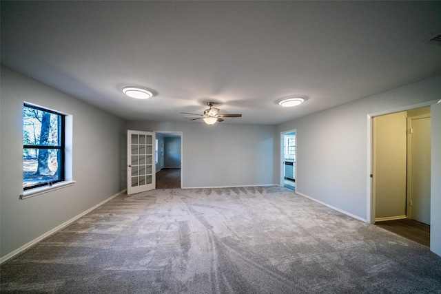 carpeted empty room featuring ceiling fan