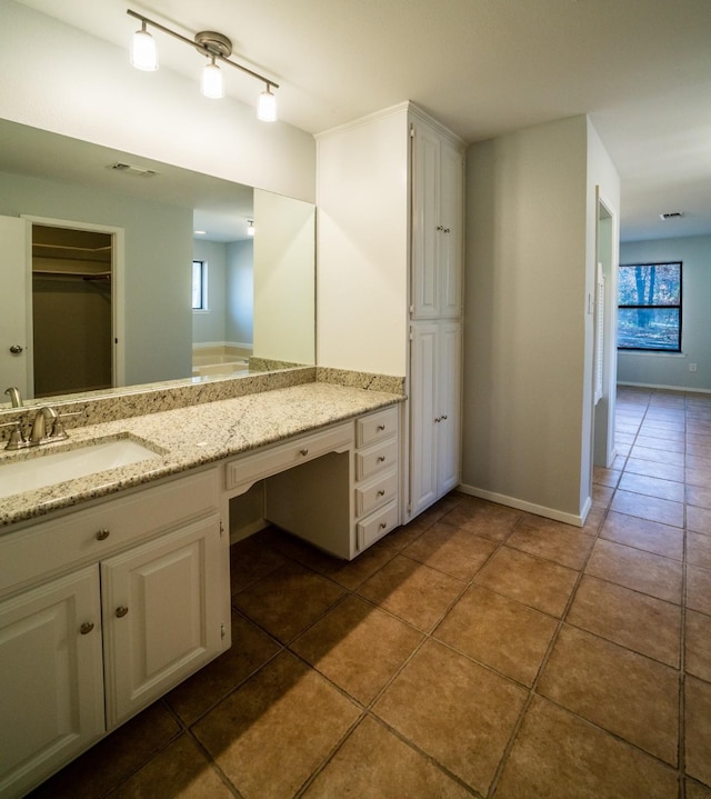 bathroom with vanity, rail lighting, and tile patterned floors