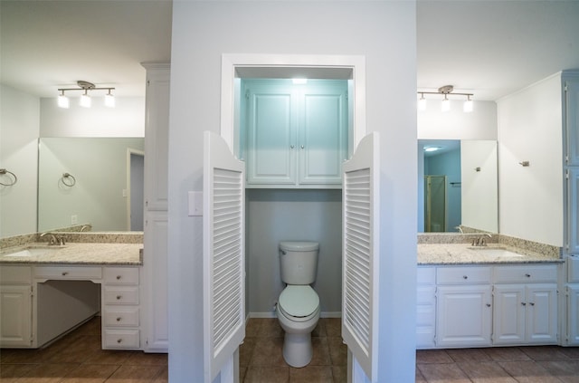 bathroom with tile patterned floors, toilet, and vanity