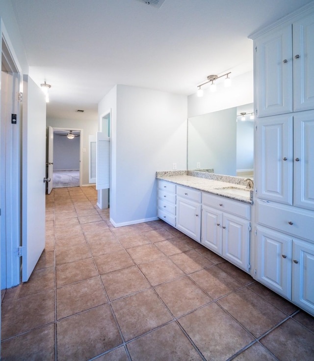 bathroom with tile patterned flooring and vanity