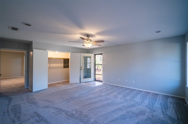 carpeted spare room with ceiling fan