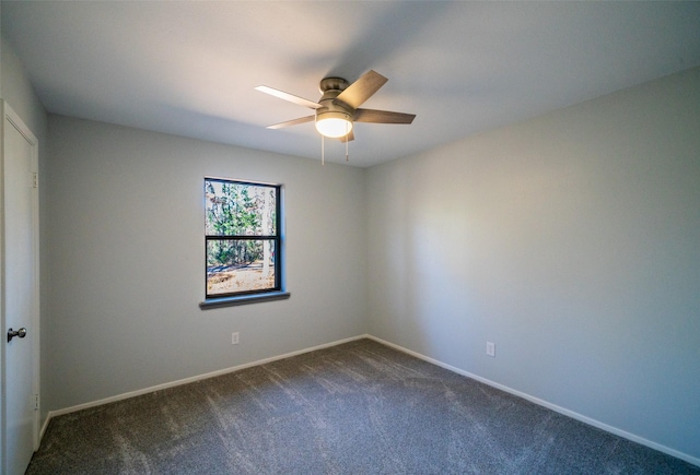 empty room with dark colored carpet and ceiling fan