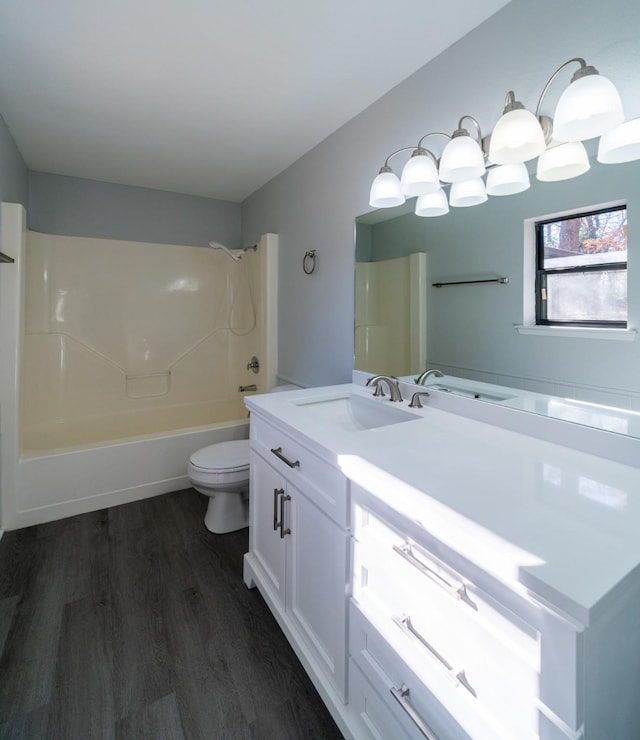 full bathroom with wood-type flooring, toilet, shower / bath combination, and vanity