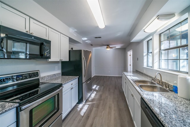 kitchen with stainless steel appliances, sink, and white cabinets