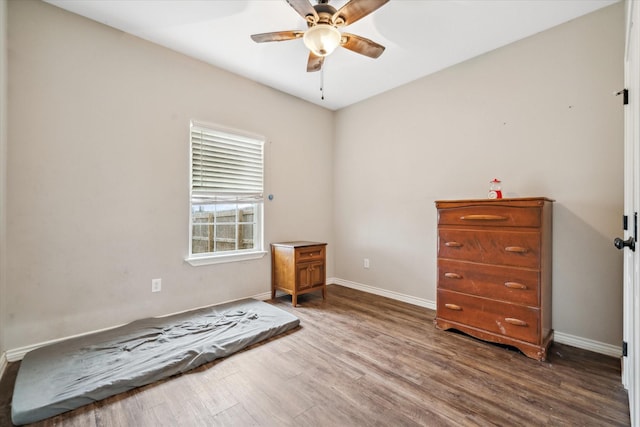 unfurnished bedroom featuring hardwood / wood-style floors and ceiling fan