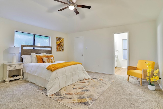 bedroom with light carpet, ceiling fan, and ensuite bathroom