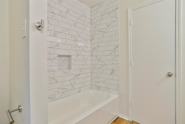 bathroom featuring tiled shower / bath