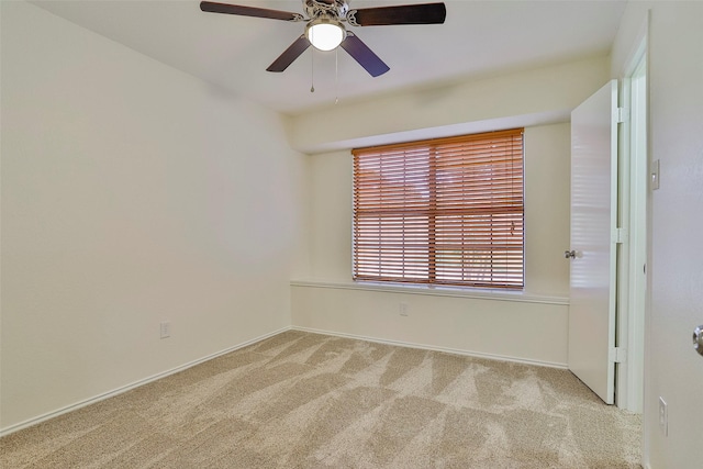 carpeted empty room featuring ceiling fan