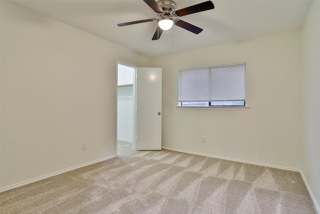 unfurnished room featuring light carpet and ceiling fan