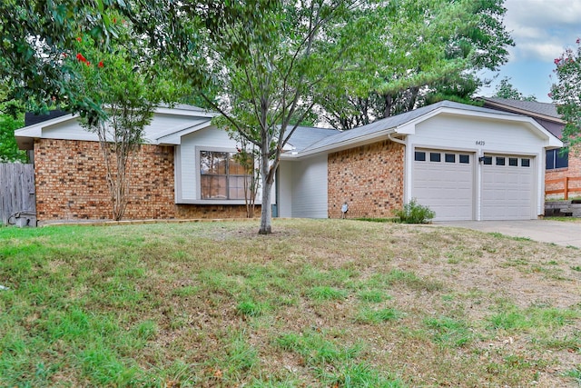 ranch-style home with a garage and a front lawn