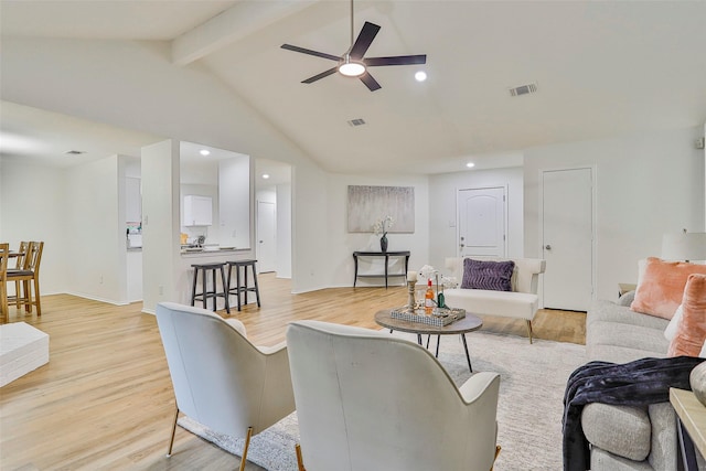 living room featuring lofted ceiling with beams, ceiling fan, and light hardwood / wood-style flooring