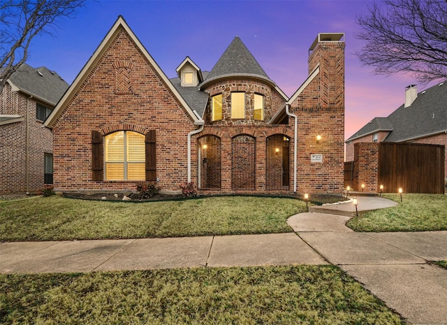 view of front of property with a lawn