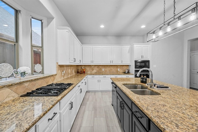 kitchen with pendant lighting, white cabinets, and black appliances