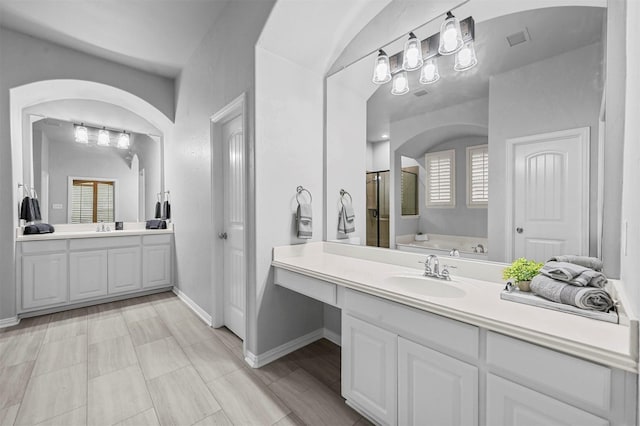 bathroom with vanity and a washtub