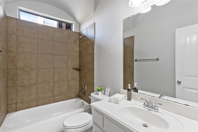 full bathroom with vanity, tiled shower / bath combo, and toilet