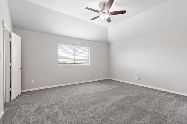 empty room featuring vaulted ceiling, carpet flooring, and ceiling fan