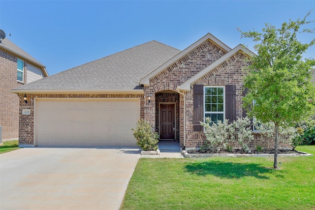 view of front of property with a garage and a front lawn