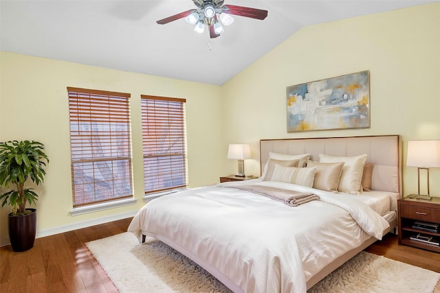 bedroom featuring hardwood / wood-style flooring, vaulted ceiling, and ceiling fan