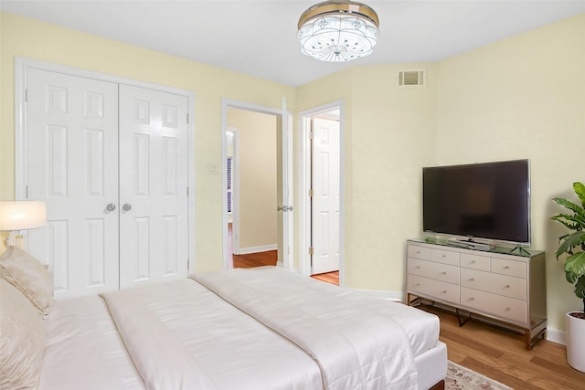 bedroom with light wood-type flooring and a closet