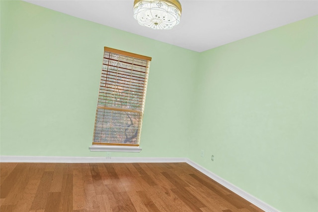 unfurnished room with hardwood / wood-style flooring