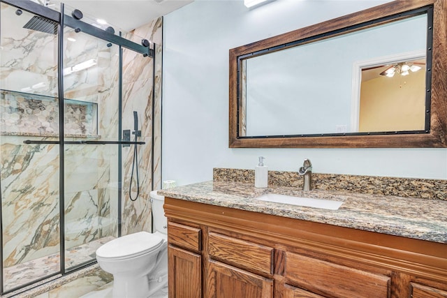 bathroom with vanity, toilet, and a shower with shower door