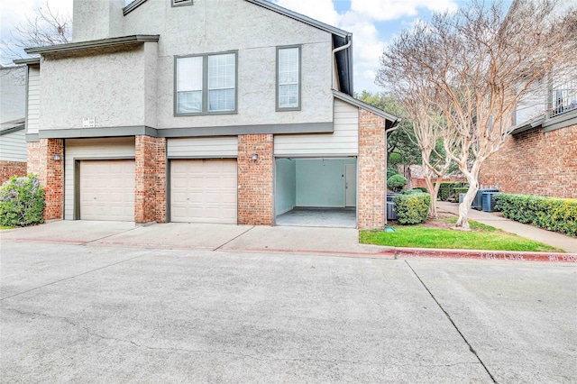 exterior space with central AC unit and a garage