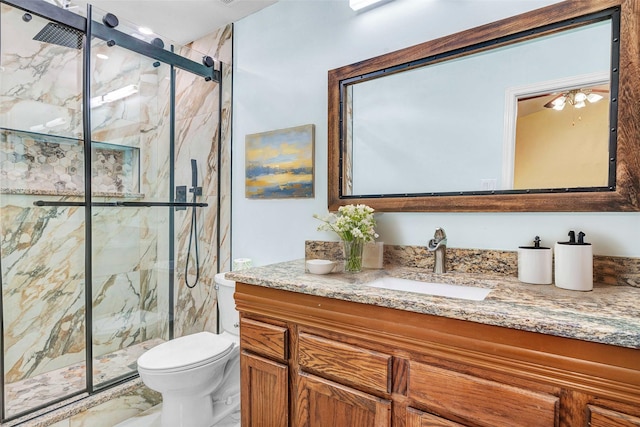 bathroom featuring vanity, toilet, and an enclosed shower