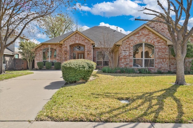 3108 Fernhurst Dr, Richardson, TX 75082 - view of front of house with brick siding, roof with shingles, and a front yard