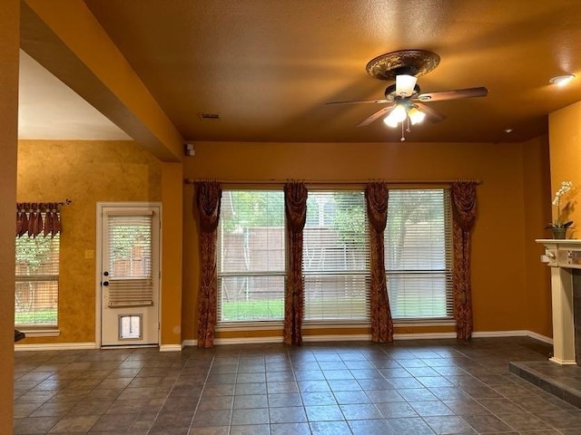 doorway to outside featuring ceiling fan and a healthy amount of sunlight