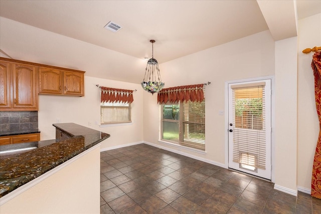 3108 Fernhurst Dr, Richardson, TX 75082 - unfurnished dining area with baseboards and visible vents