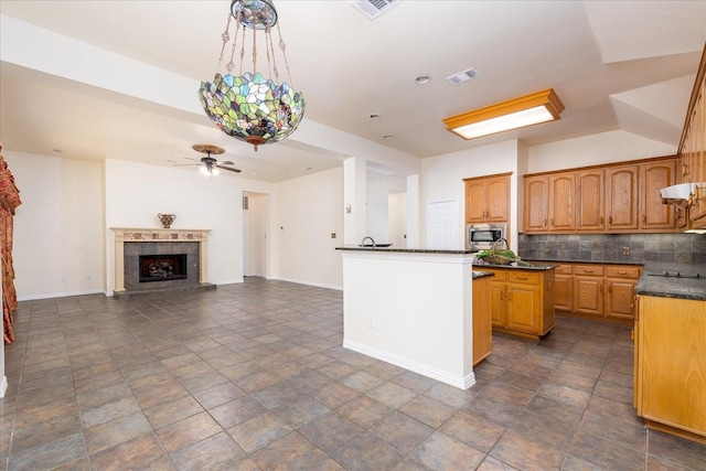 3108 Fernhurst Dr, Richardson, TX 75082 - kitchen with stainless steel microwave, a ceiling fan, baseboards, and decorative backsplash